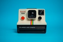 A front-facing Polaroid camera.